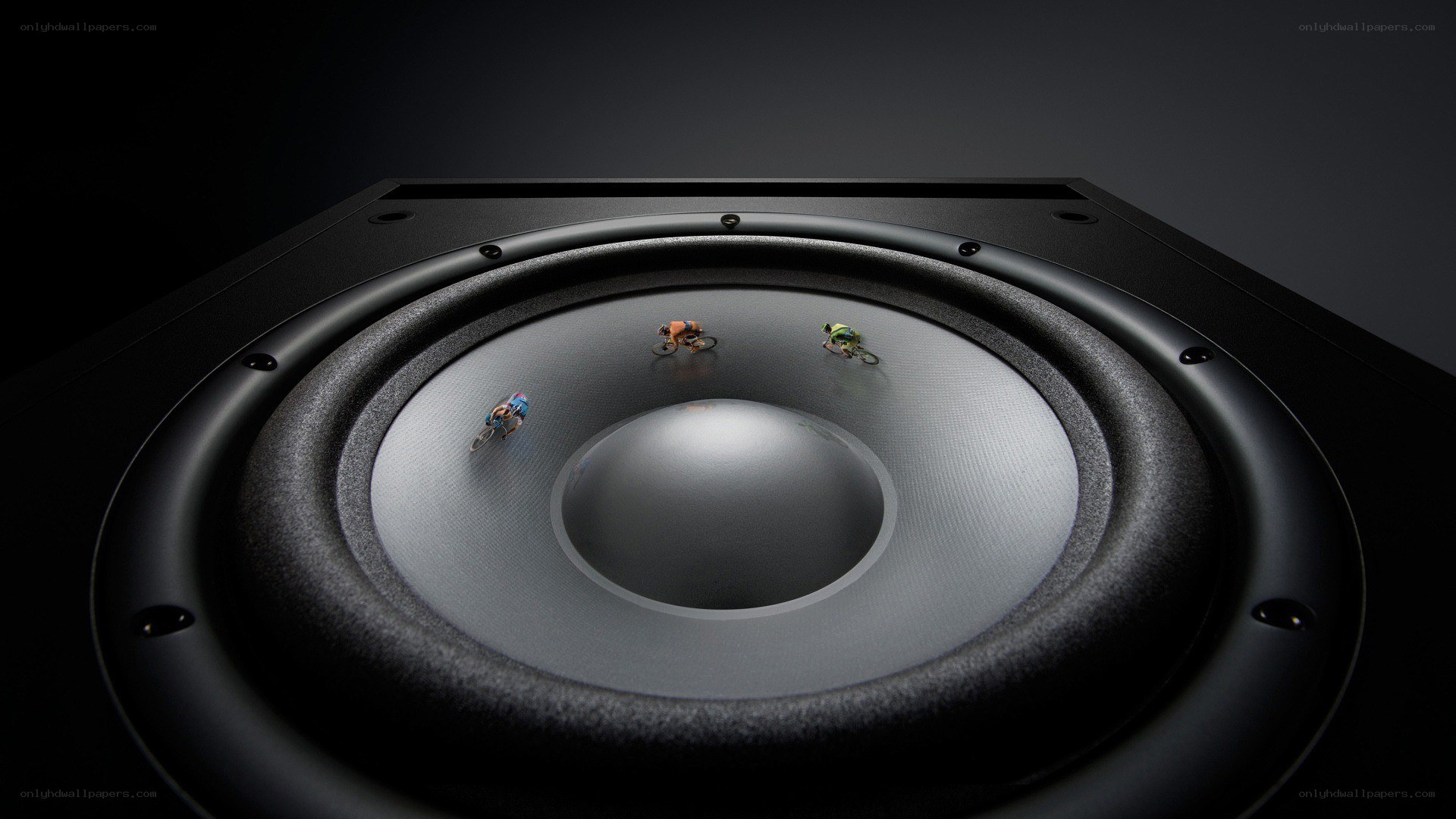 Miniature cyclists on speaker cone