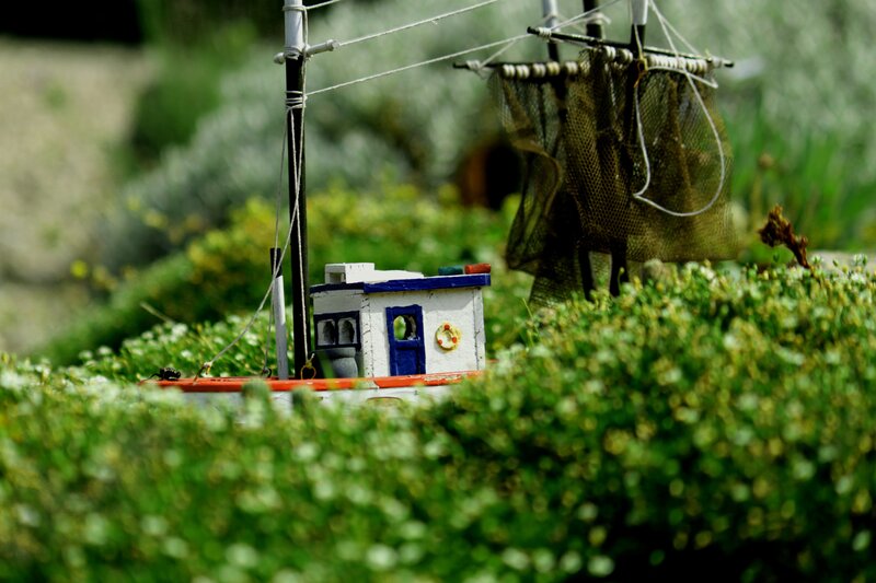 Miniature fishing boat in garden