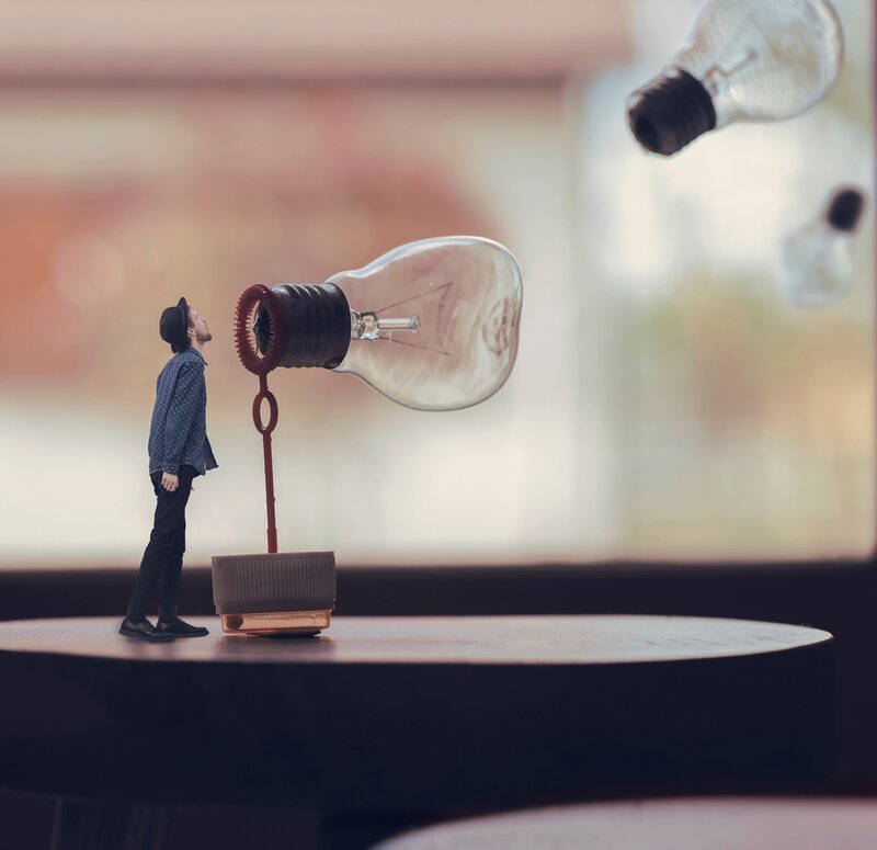 Miniature Man with Light Bulb