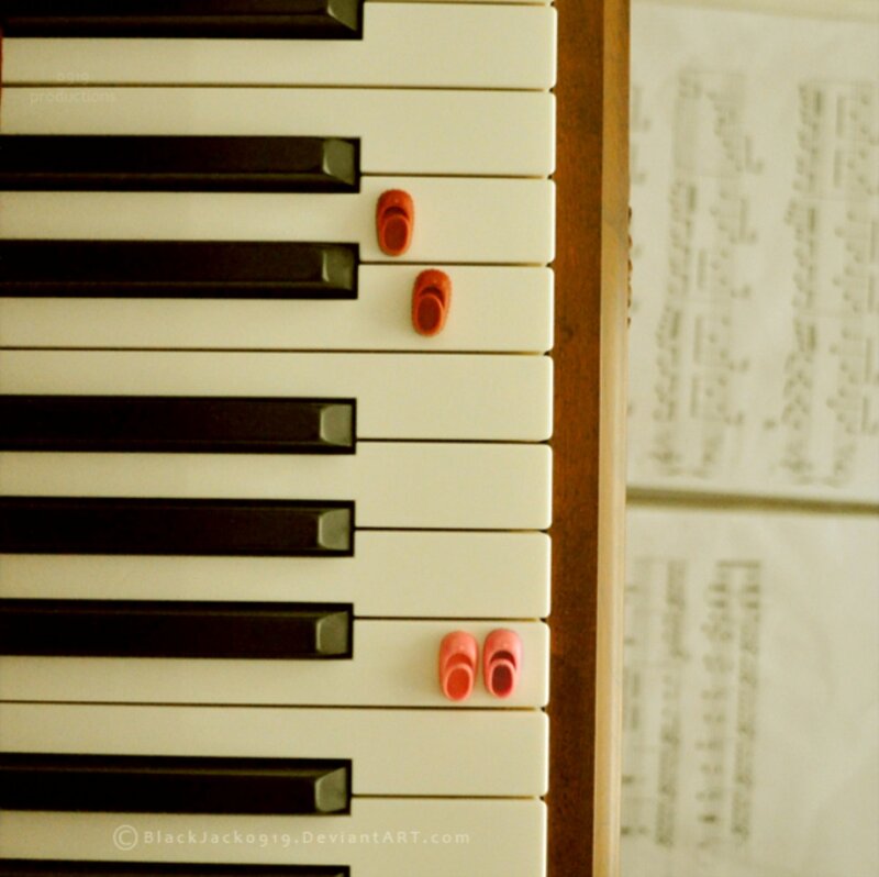 Miniature Shoes on Piano Keys