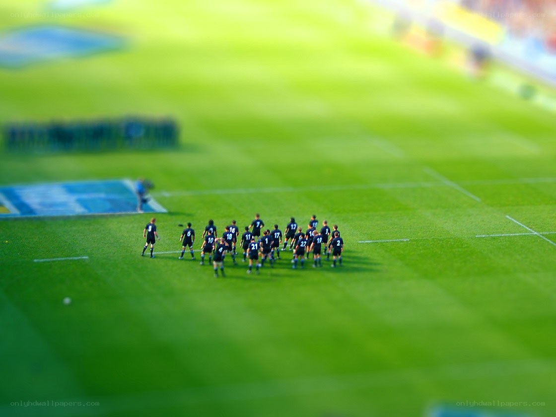 Miniature soccer team on field