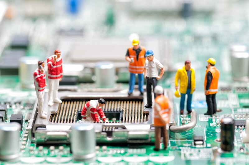 Miniature Workers on Circuit Board — Green