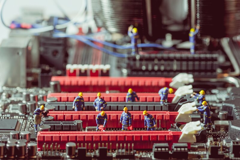 Miniature Workers on Circuit Board