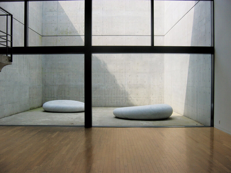 Minimalist art gallery with stone sculptures