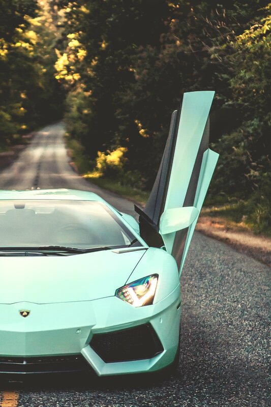 mint green sports car on road