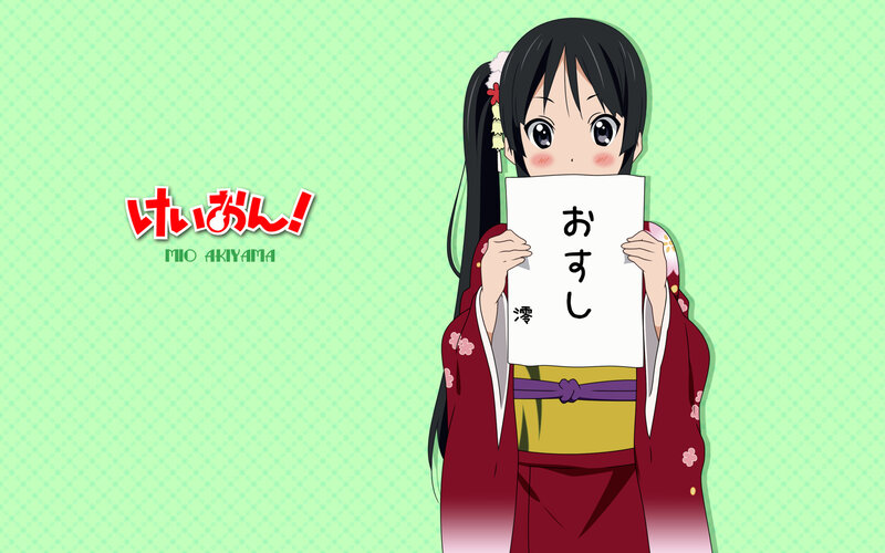 Mio Akiyama holding a sign