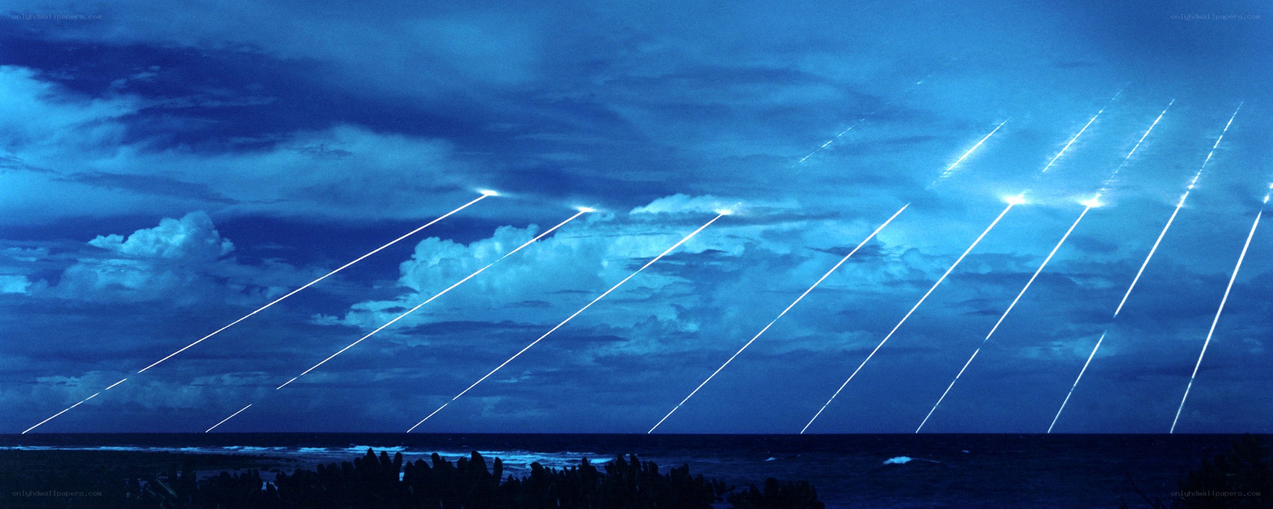 Missiles launching over ocean