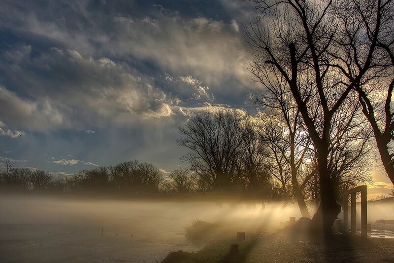 Mist over a frozen river at sunrise