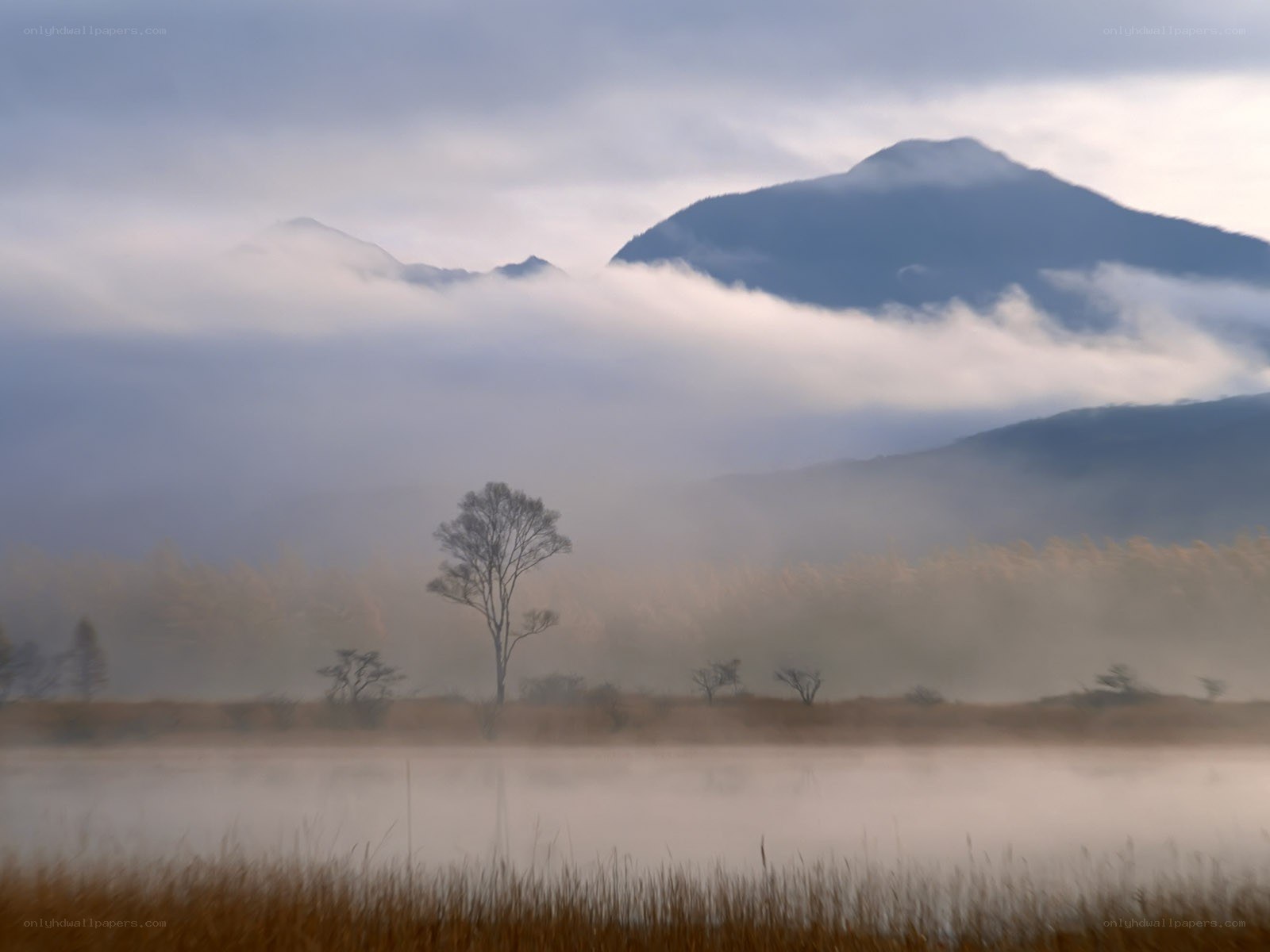 Mist over lake with mountains