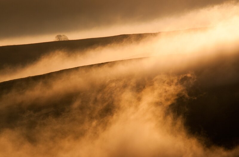 Mist over rolling hills