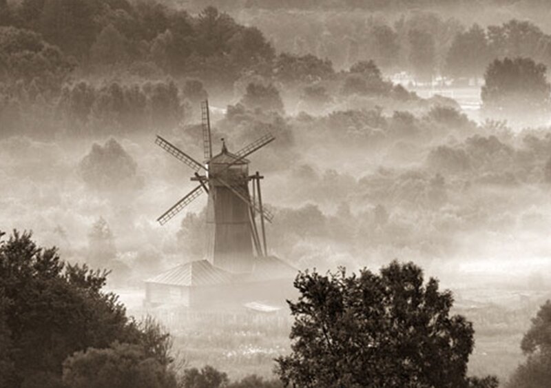 Mist over windmill landscape