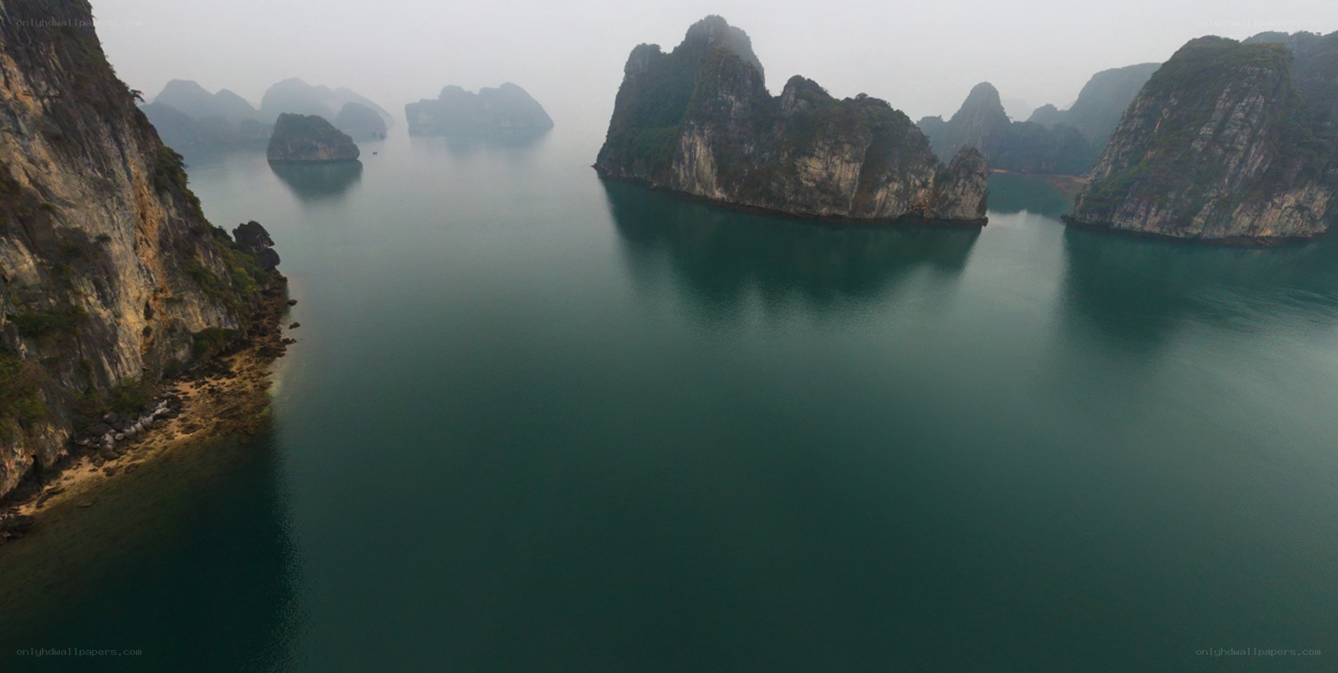 misty bay with limestone islands