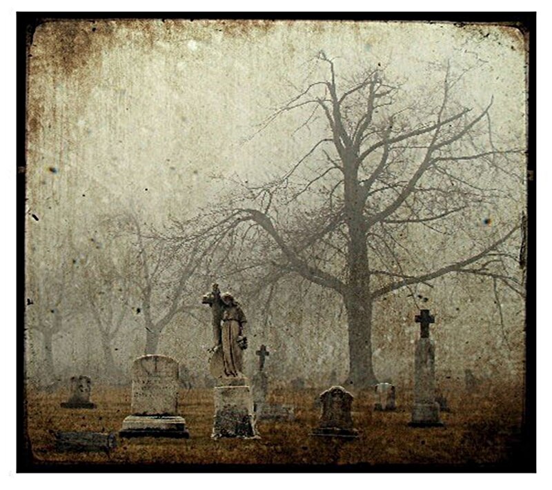 Misty cemetery with statues