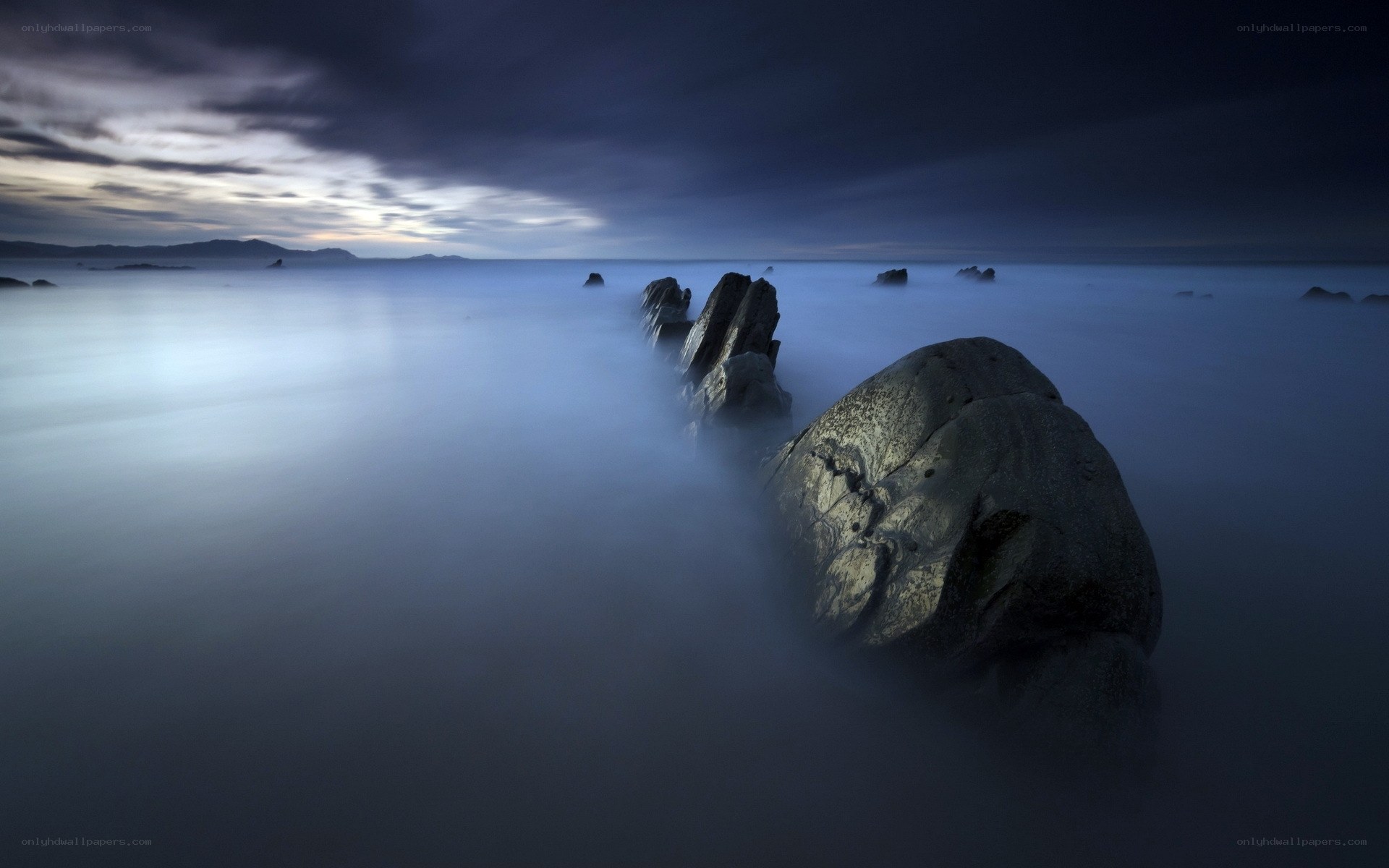 Misty coastal rocks at dusk