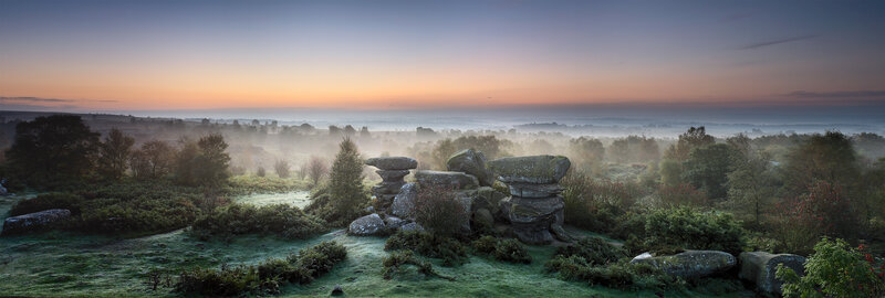 Misty dawn over rocky moor