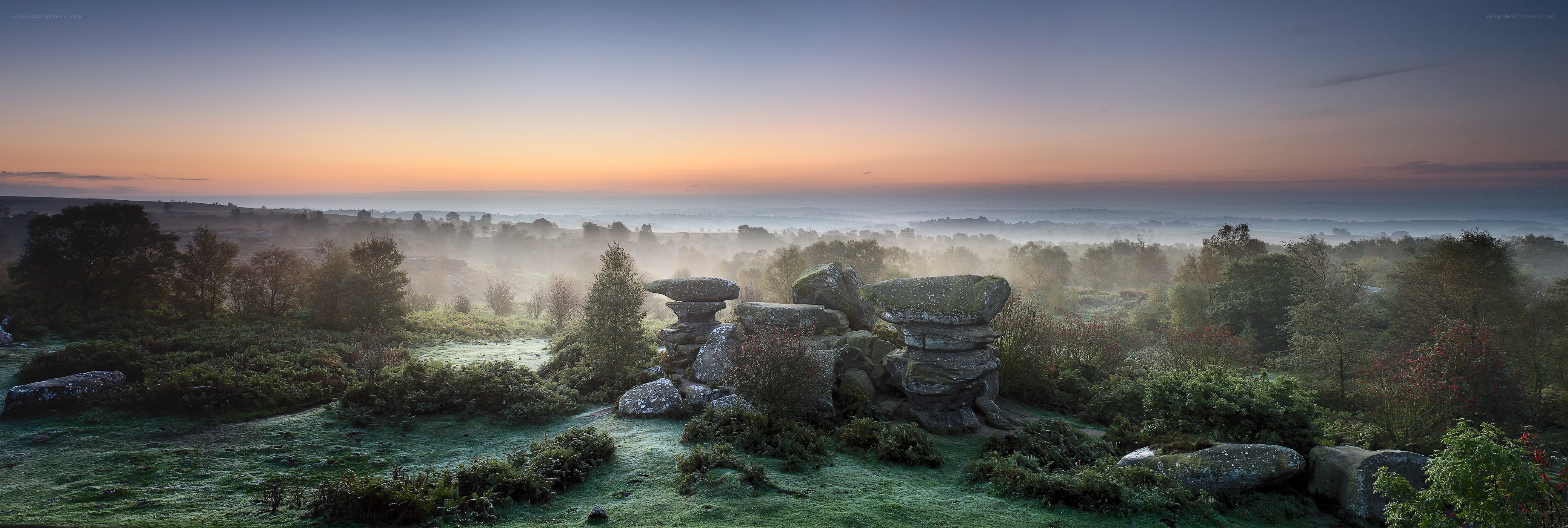 Misty dawn over rocky moor