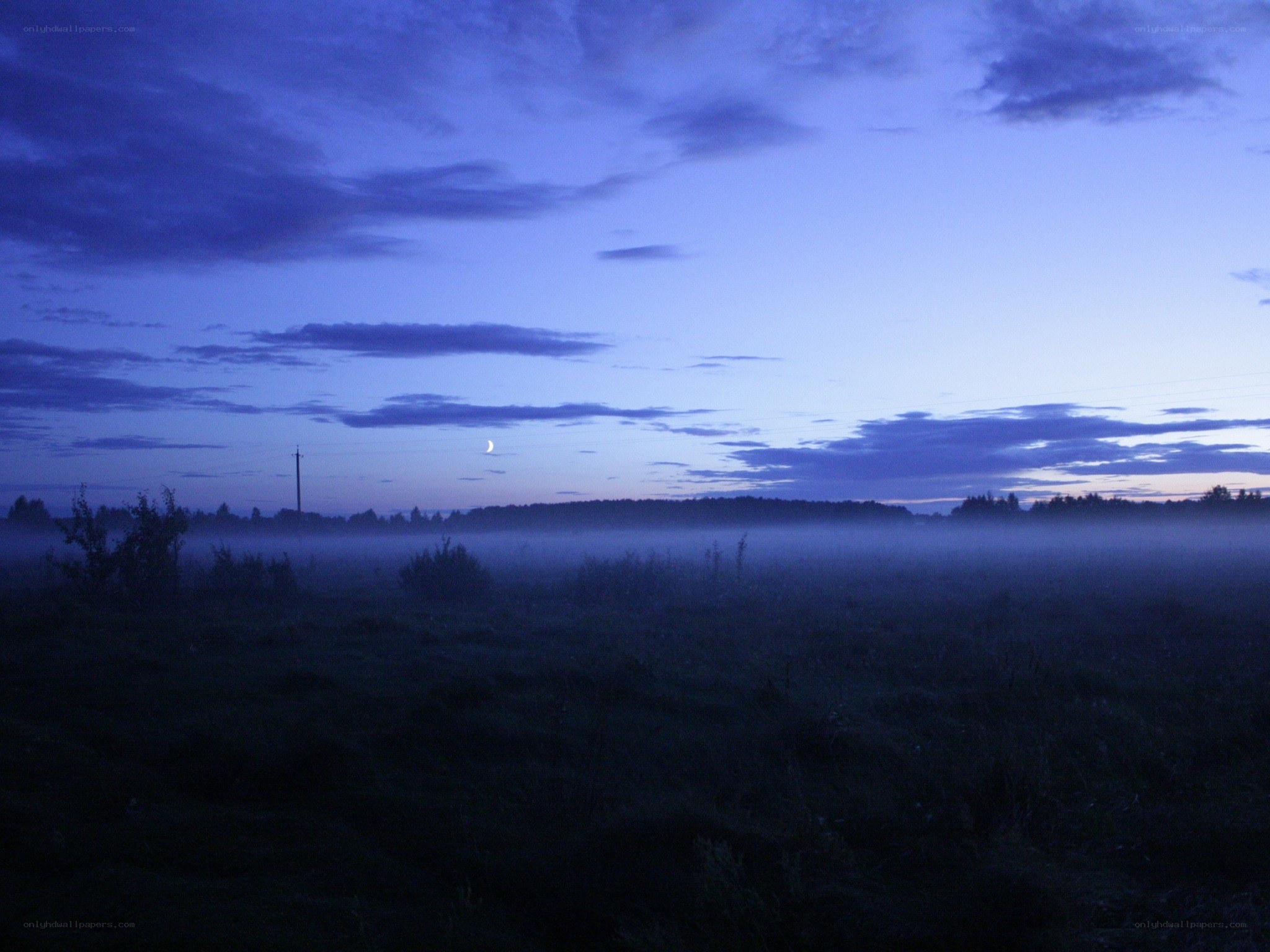 Misty dawn with crescent moon