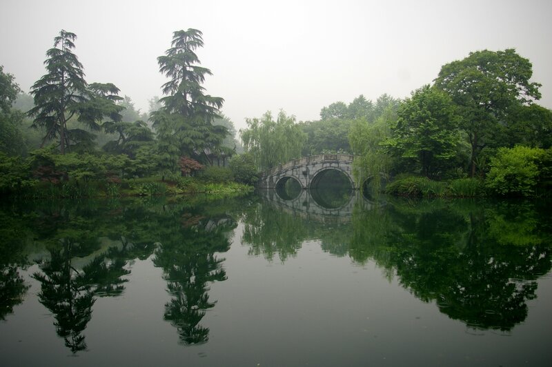Misty garden with stone bridge