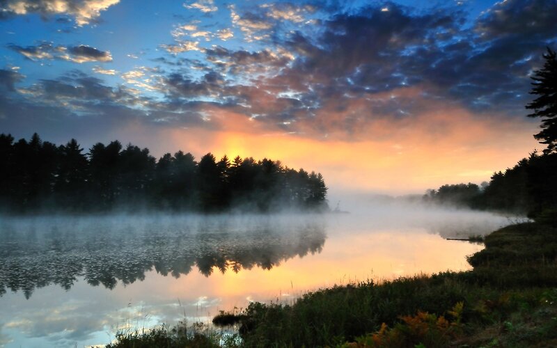 Misty lake at sunrise