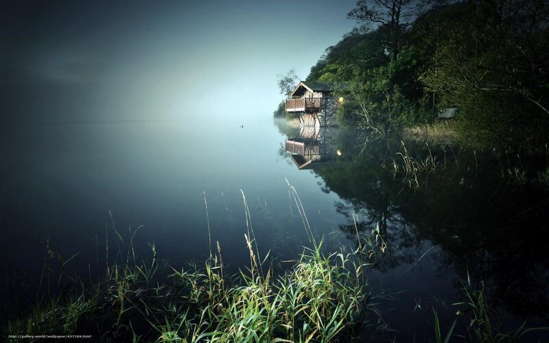 Misty lake cabin at dawn