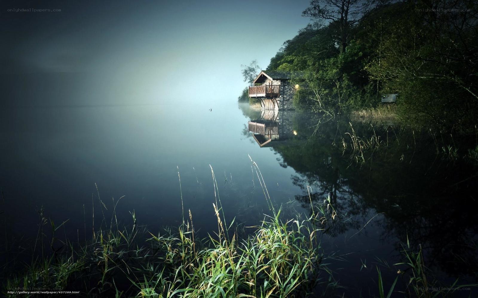Misty lake cabin at dawn