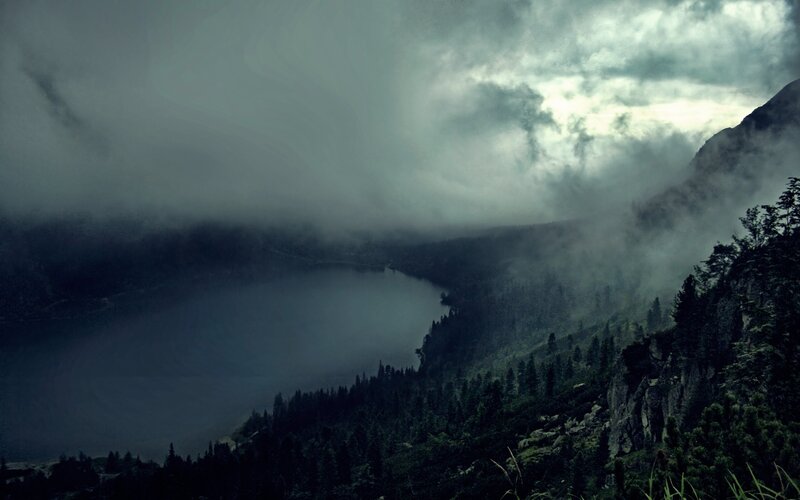 Misty lake in mountain valley