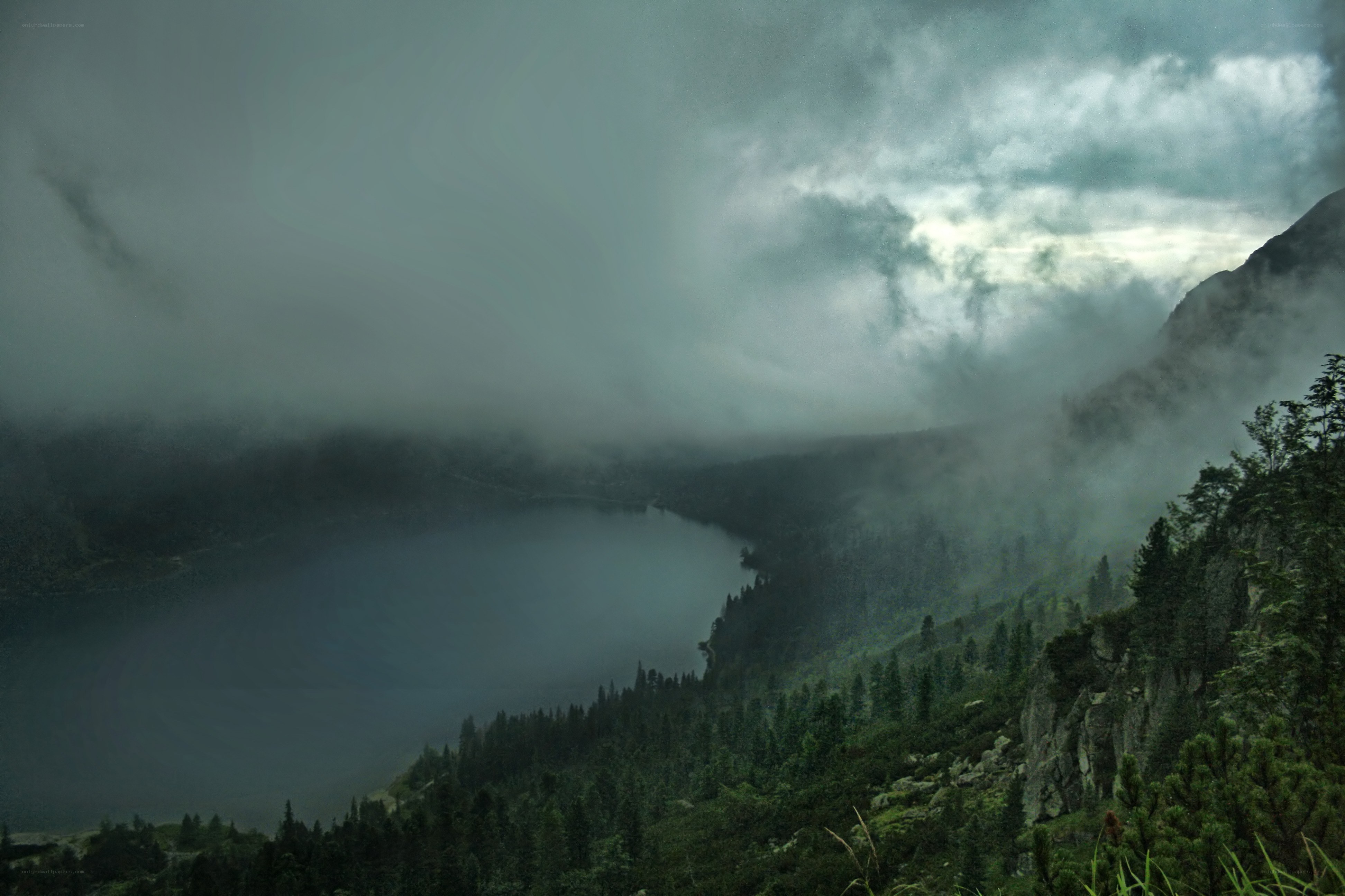 Misty lake in mountain valley