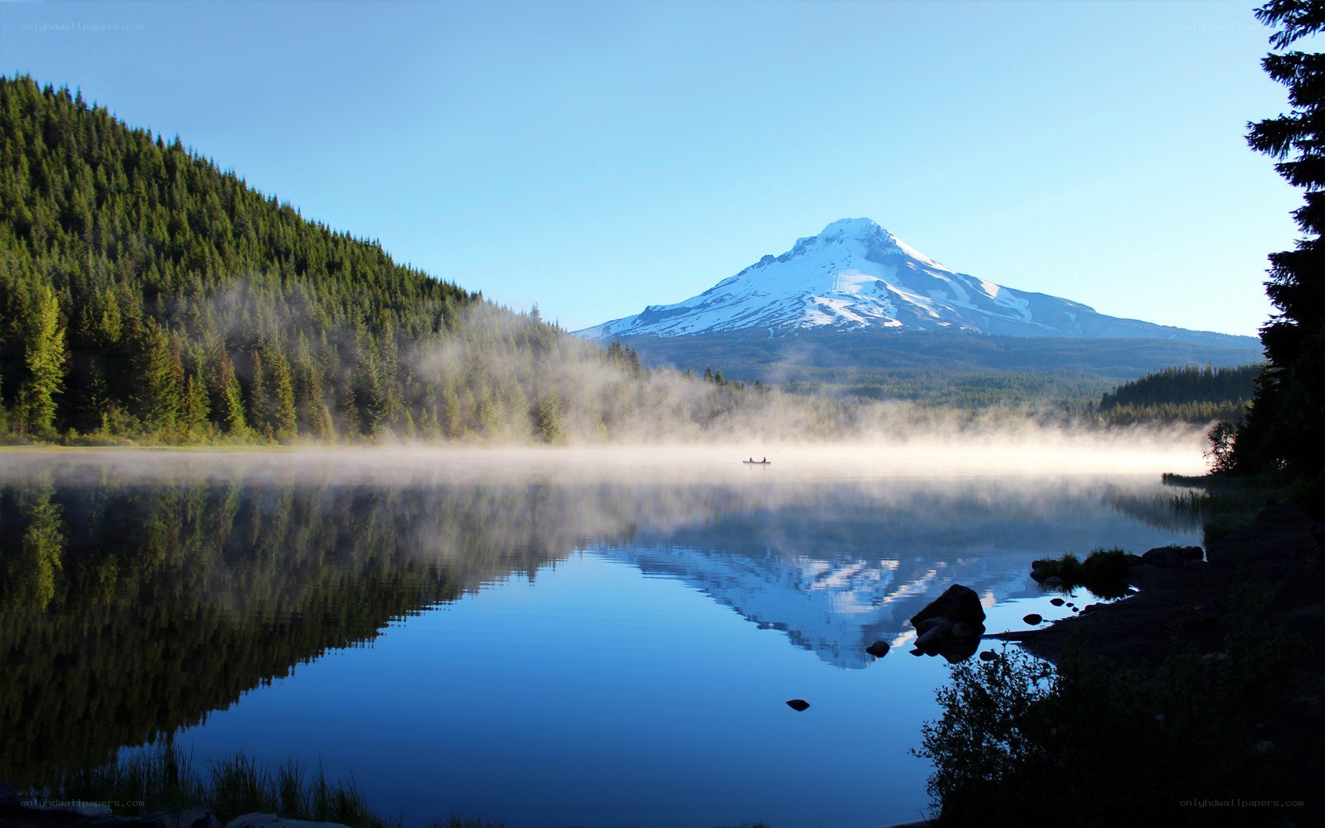 Misty lake with mountain reflection