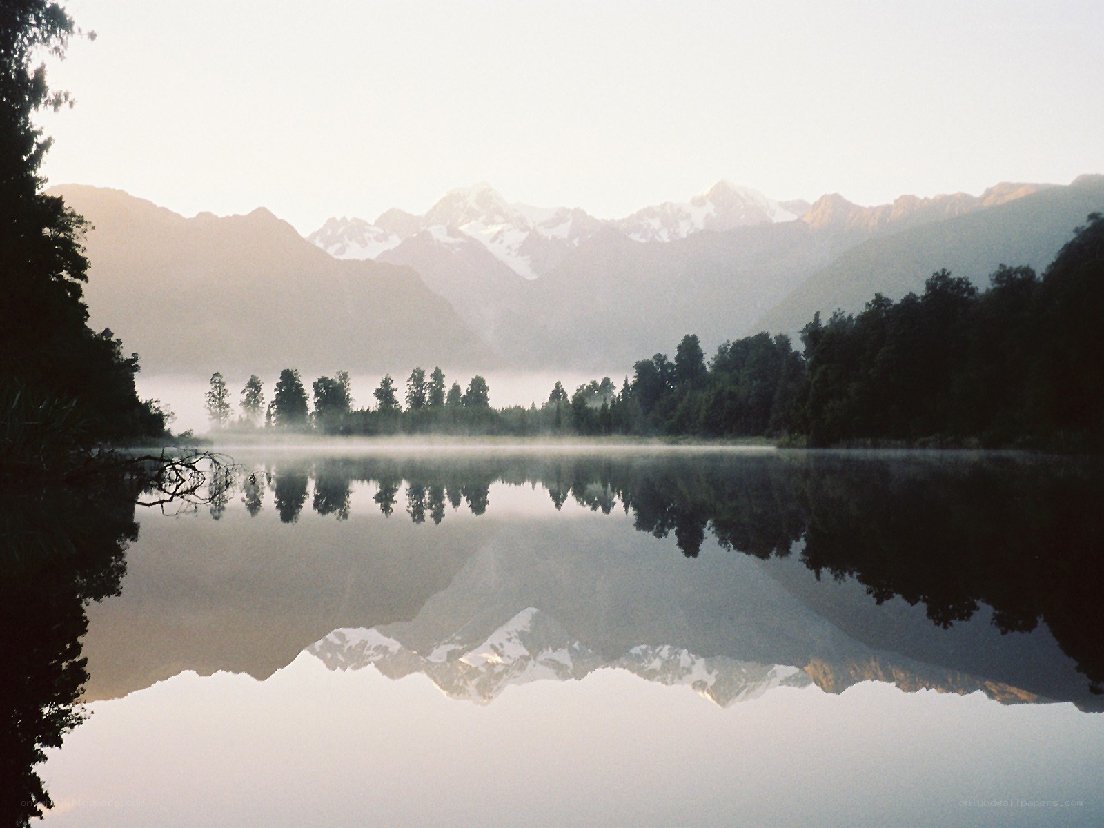 Misty lake with mountain reflection