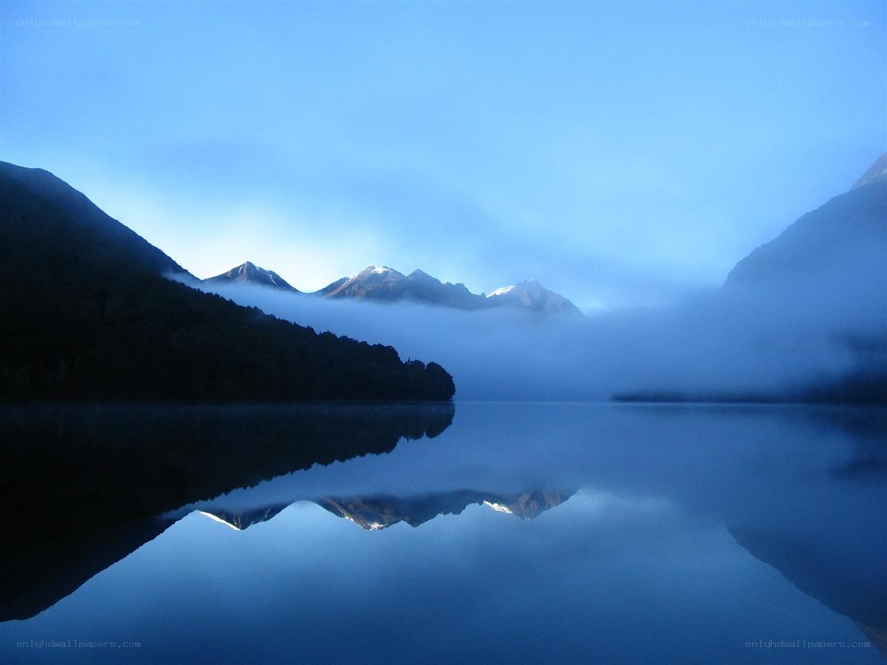 Misty lake with mountain reflection
