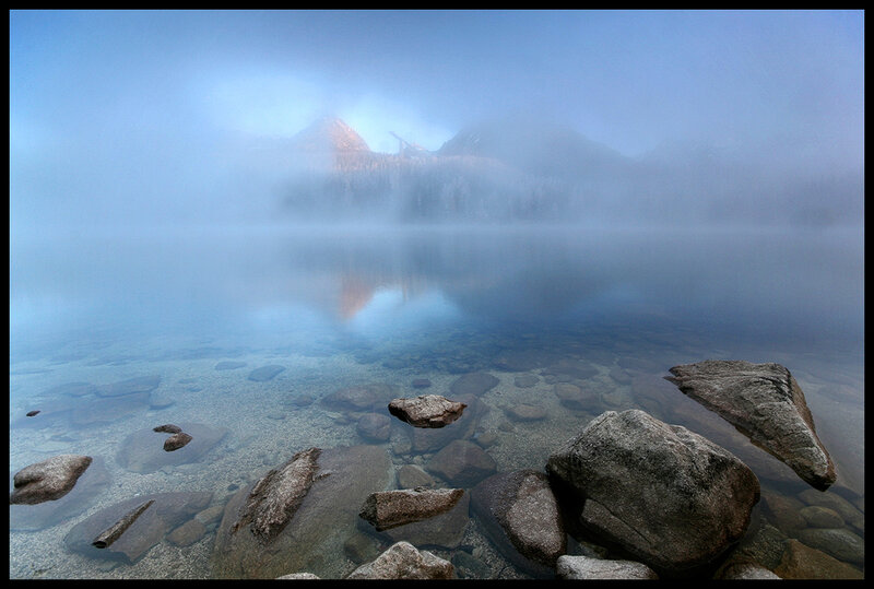 Misty lake with mountain reflection