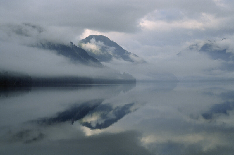 Misty lake with mountain reflection