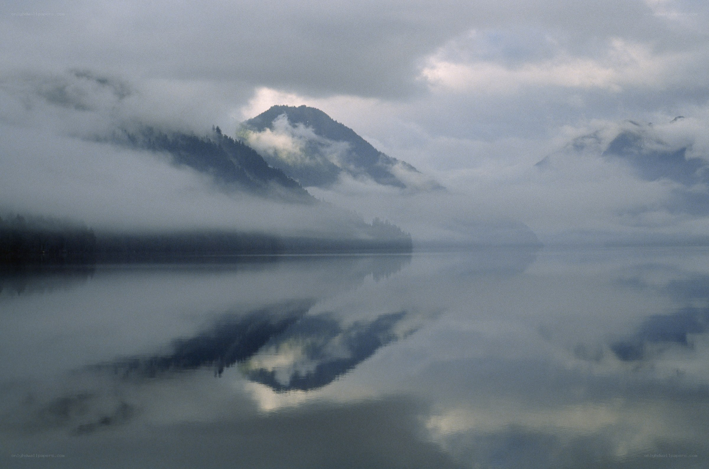 Misty lake with mountain reflection