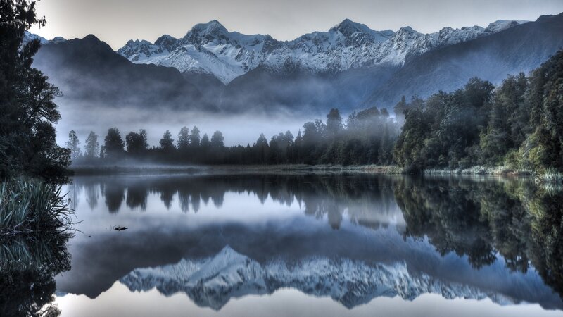 Misty lake with mountain reflection