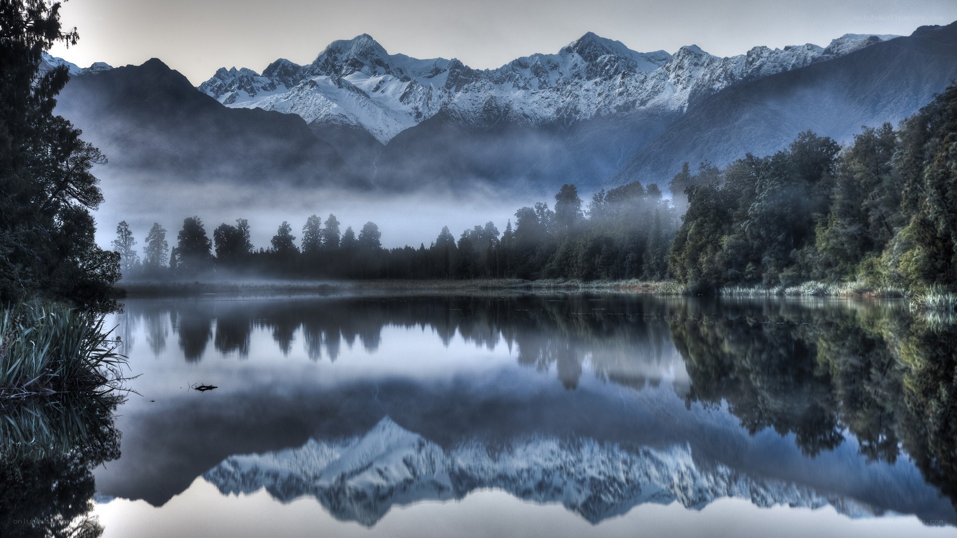 Misty lake with mountain reflection