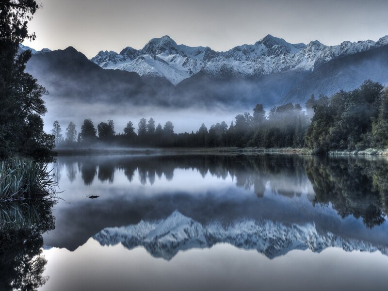 Misty lake with mountain reflection