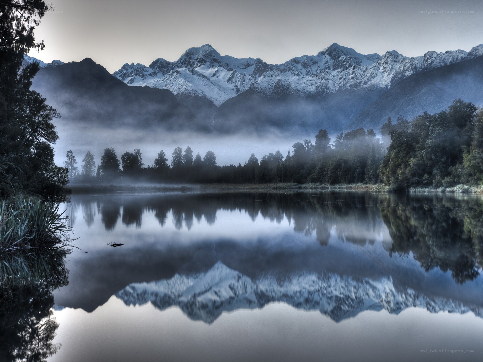 Misty lake with mountain reflection