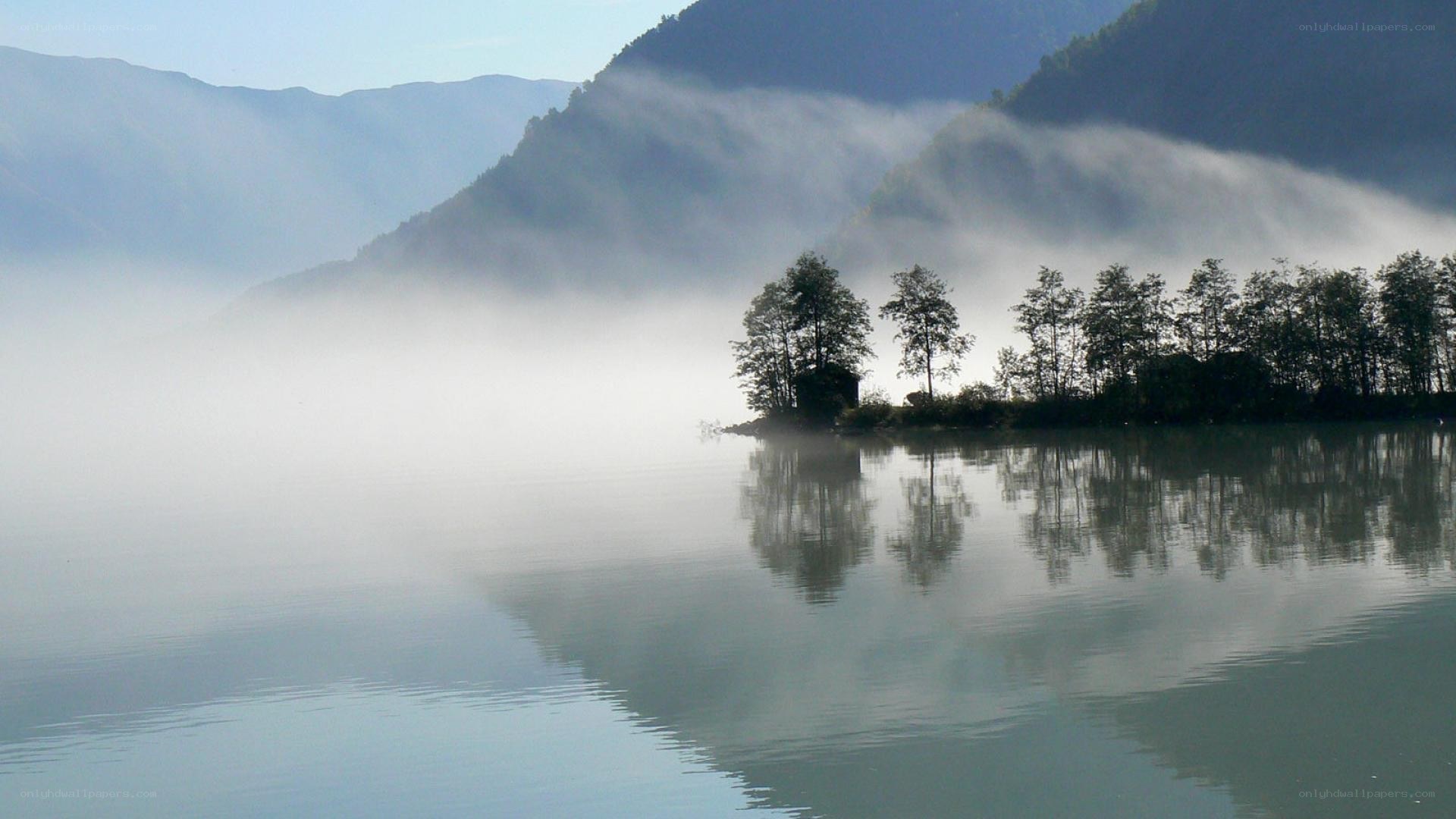 Misty lake with mountain reflection