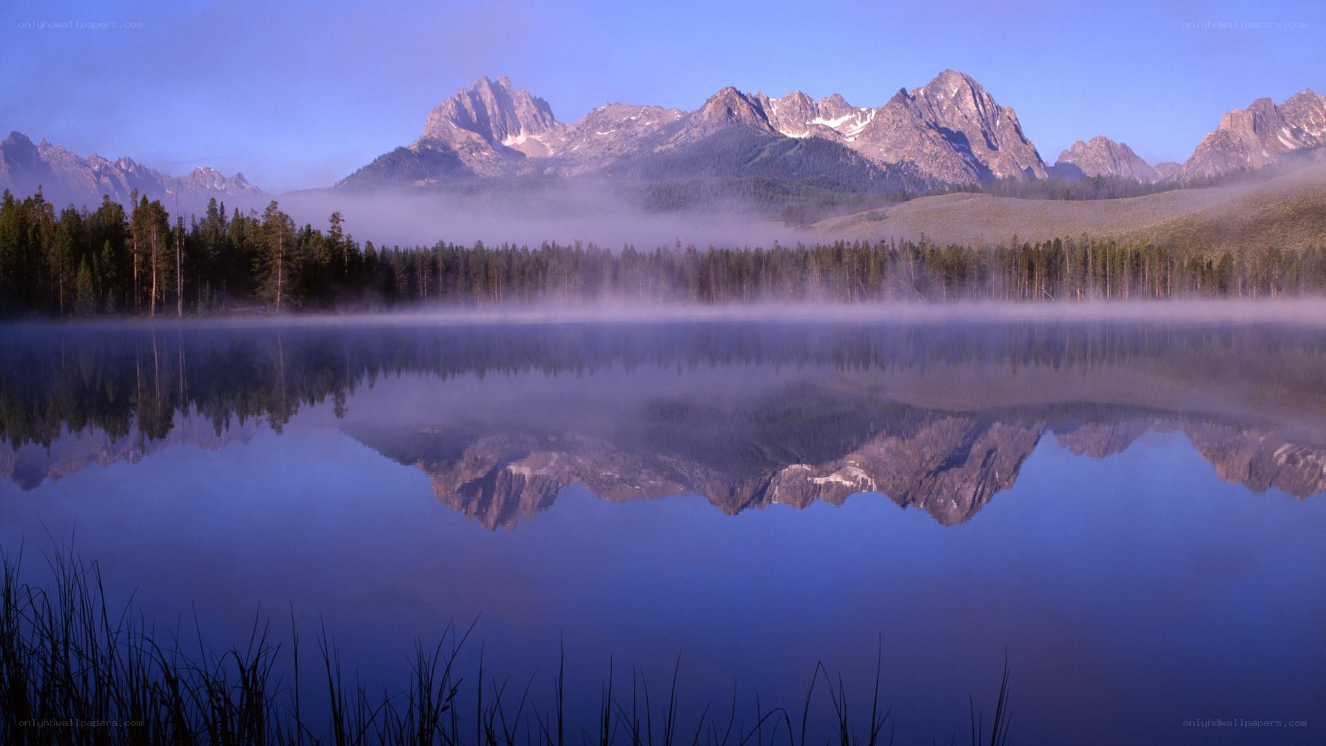 Misty lake with mountain reflection