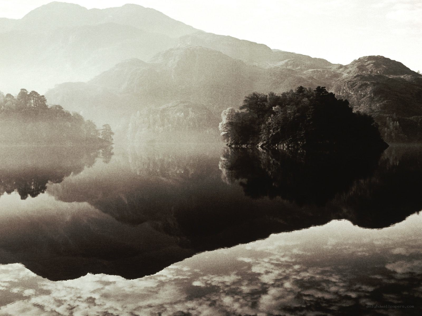Misty lake with mountain reflections