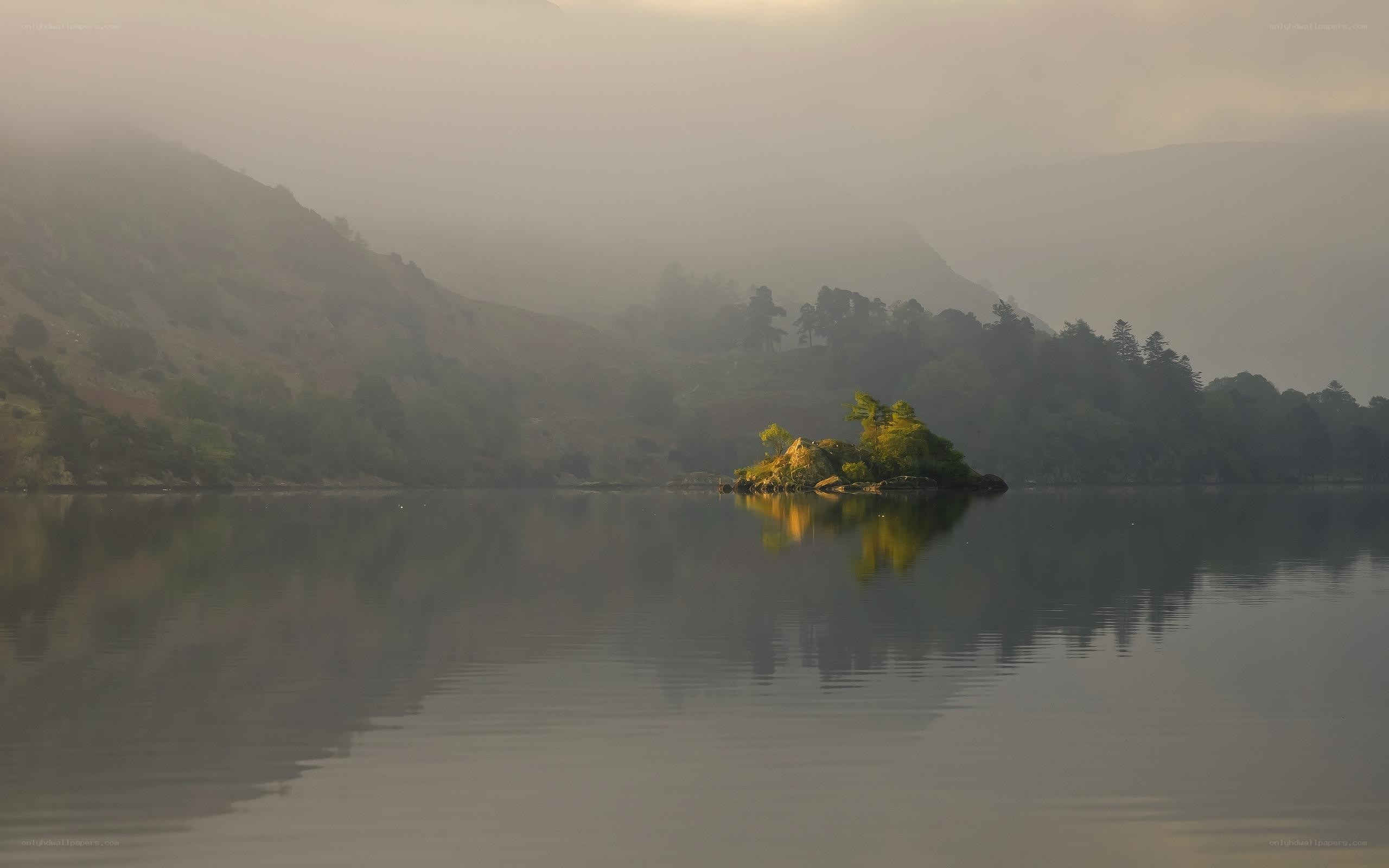 Misty lake with small island