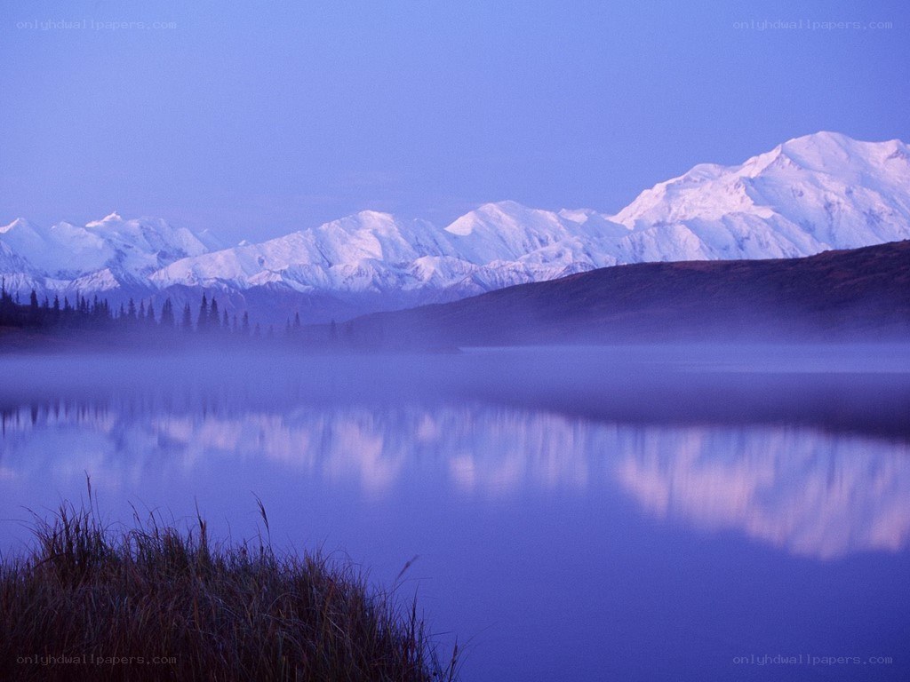 Misty lake with snow-capped mountains