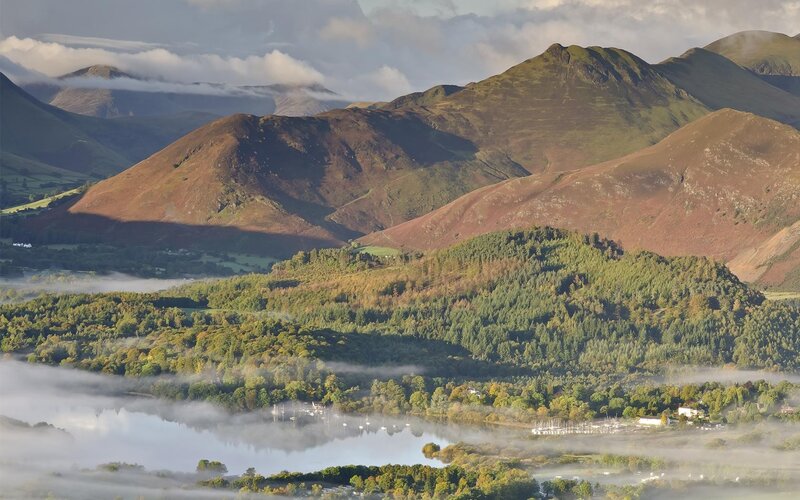 Misty morning over a lake and mountains