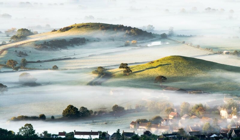 Misty morning over rolling hills