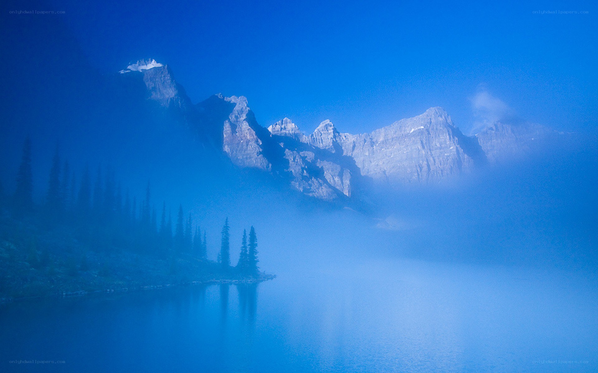 Misty mountain lake at dawn