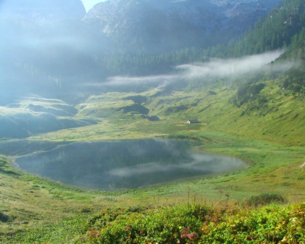Misty mountain lake at dawn