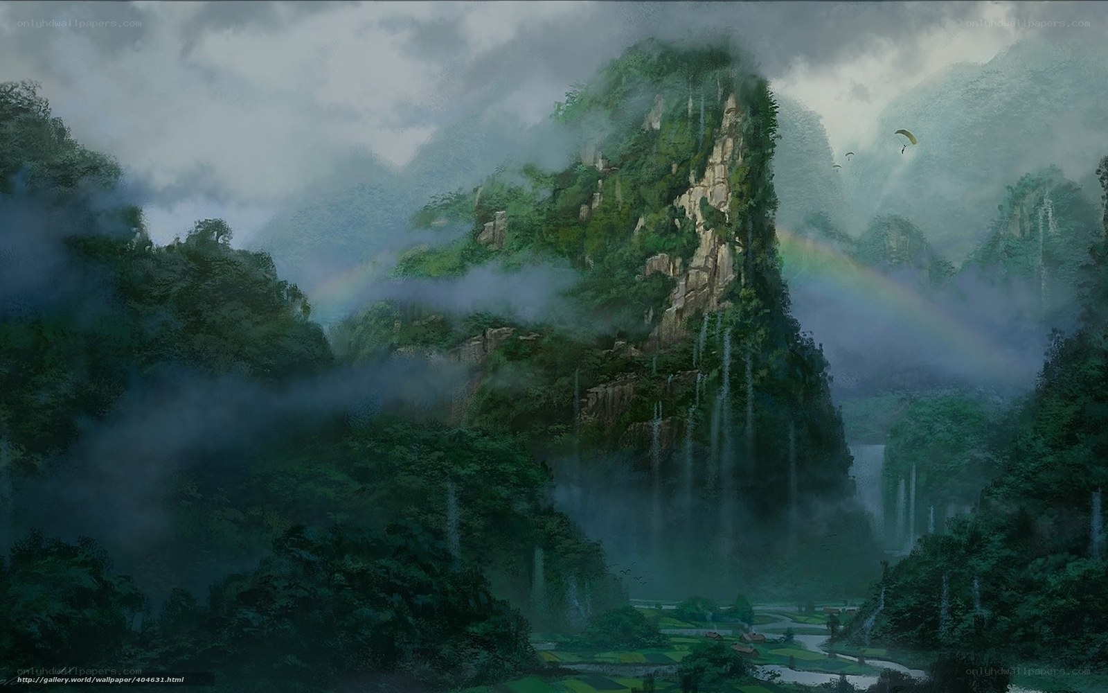 Misty mountain landscape with rainbow
