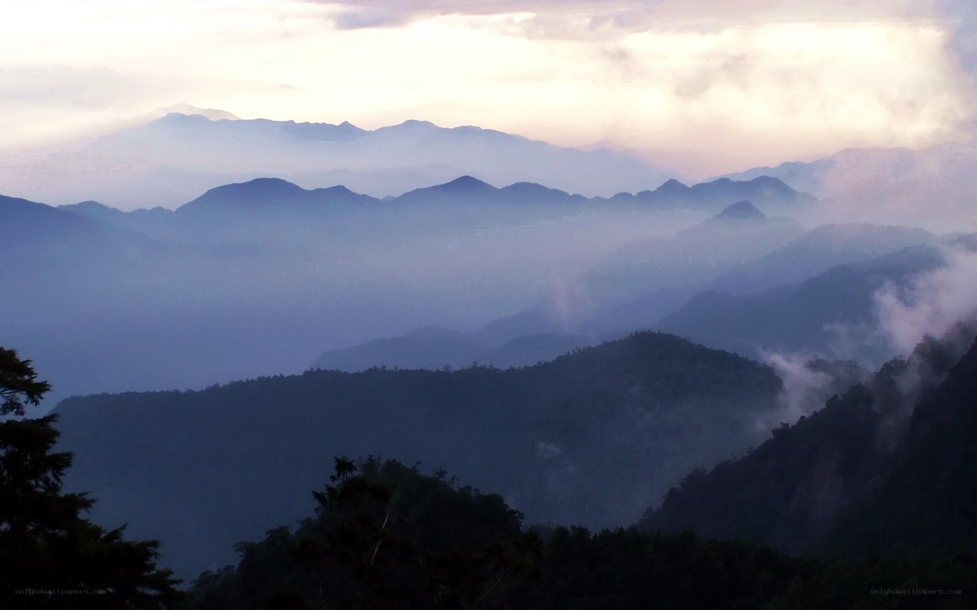 misty mountain ranges at dawn