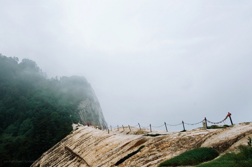 Misty mountain trail with railings