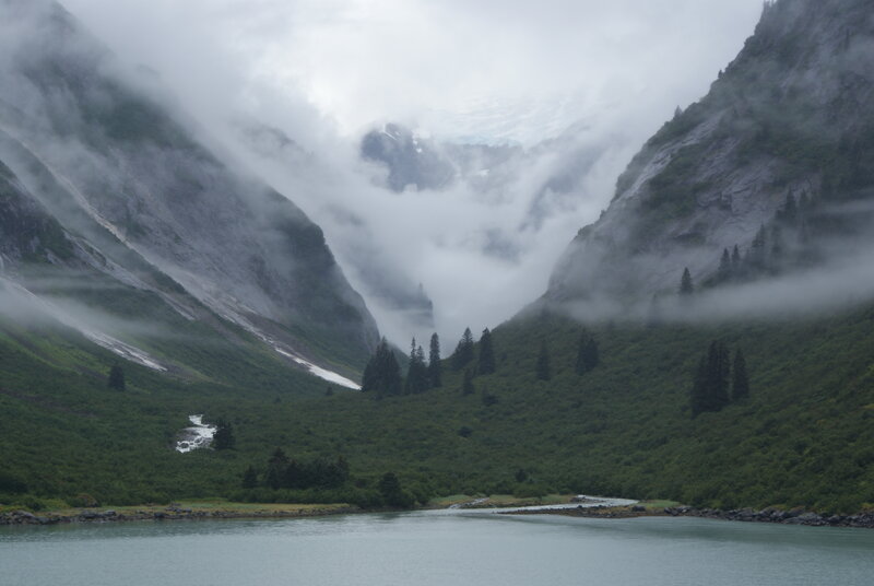 Misty mountain valley with lake